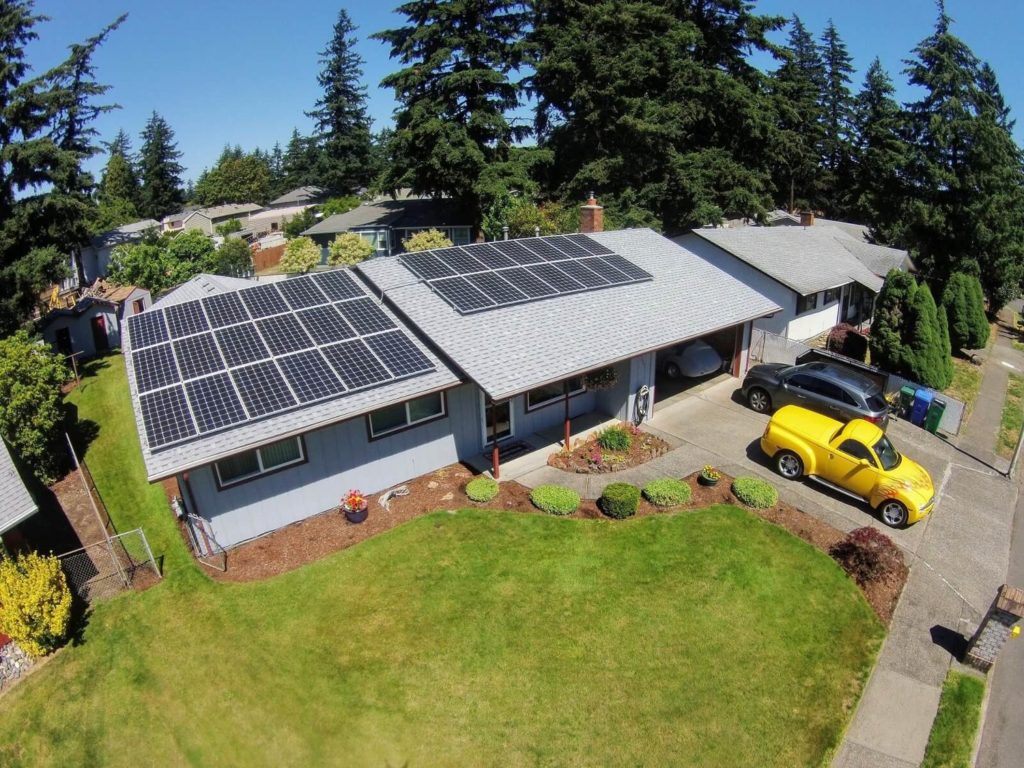 100% offset solar home with yellow truck in front