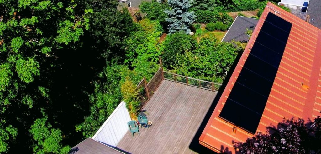 all black sunpower solar panels on a orange metal roof