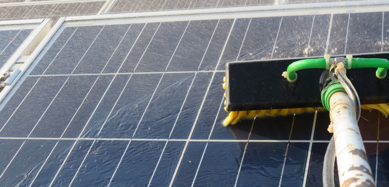 cleaning solar panels with water squeegee
