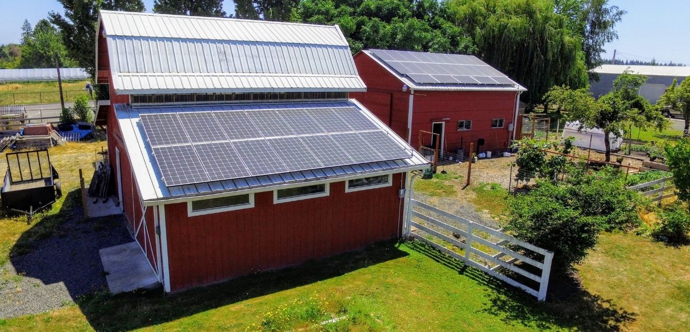 salem solar panels on a two metal barns