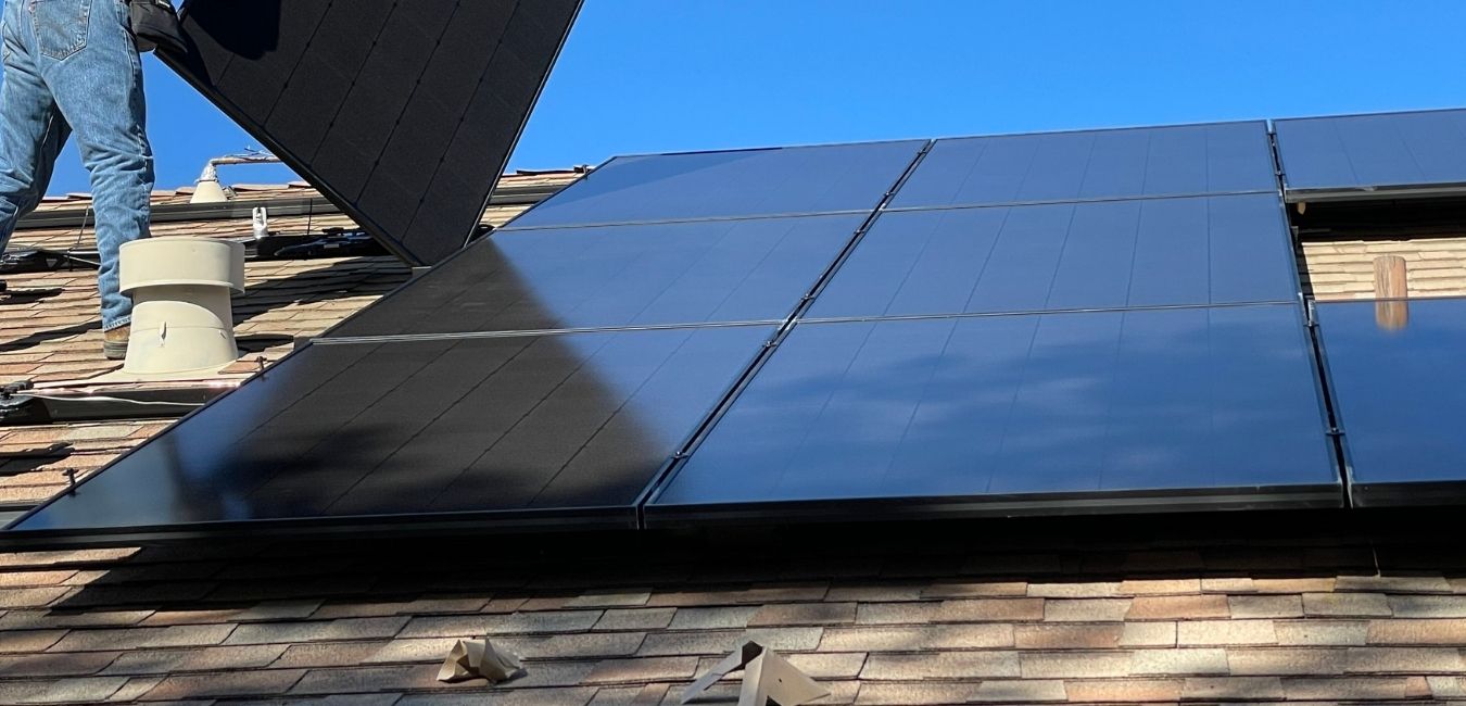 man installing leased solar panels on an oregon home