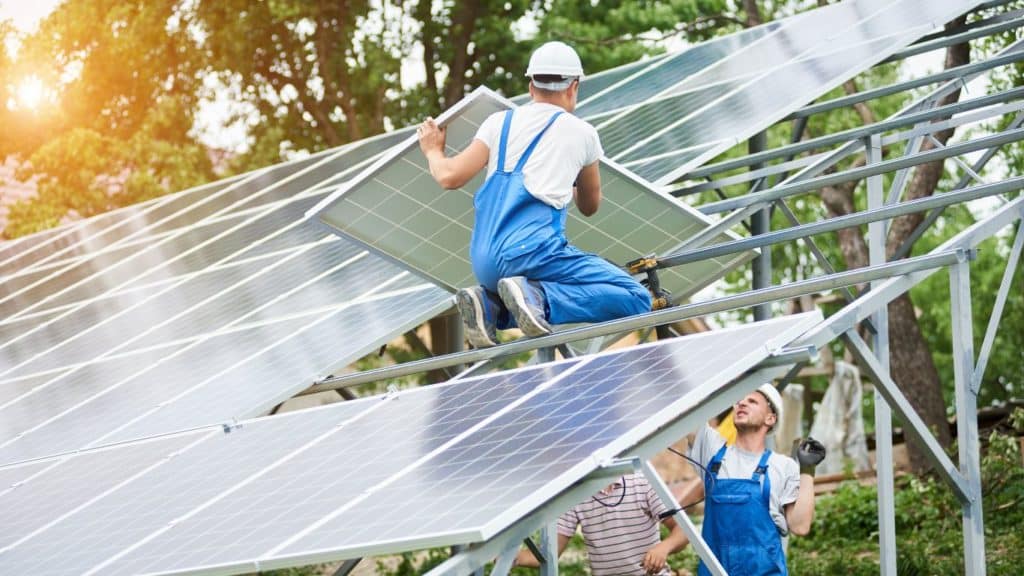 solar installers putting together a ground mount system